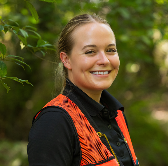 One employee smiling in forest