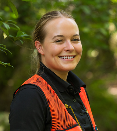 One employee smiling in forest