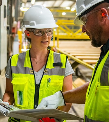 Two employees in lumber yard