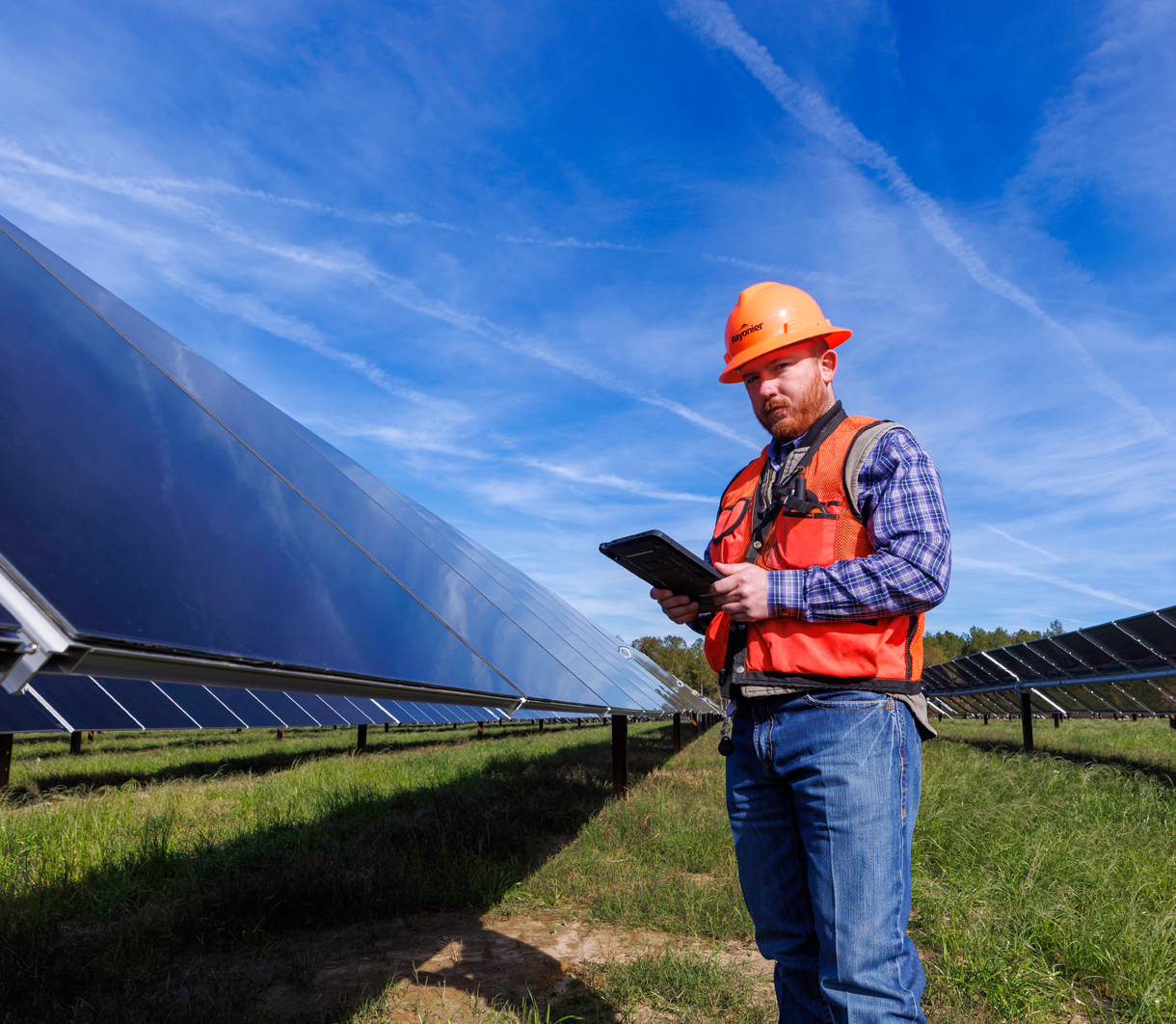 Man standing in front of solar panels