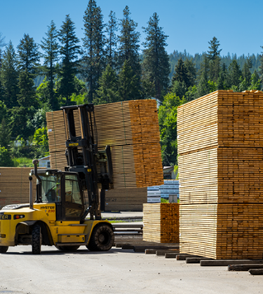 Forklift moving lumber